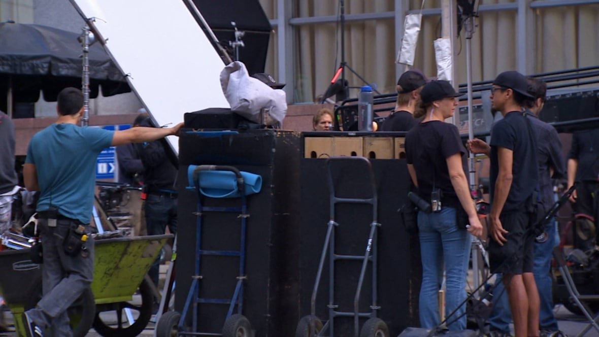film-crews Film crews stand around on set outside.
