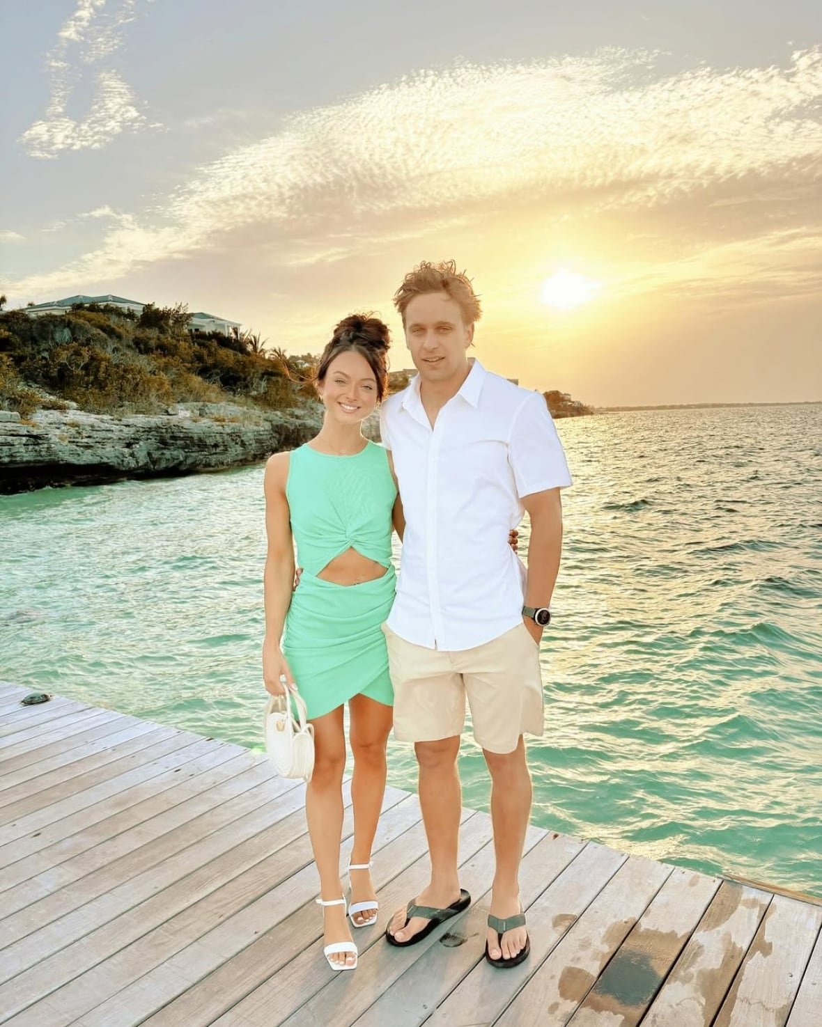 jory-macisaac-and-lucas-arsenault A woman and man stand on a boardwalk during sunset.