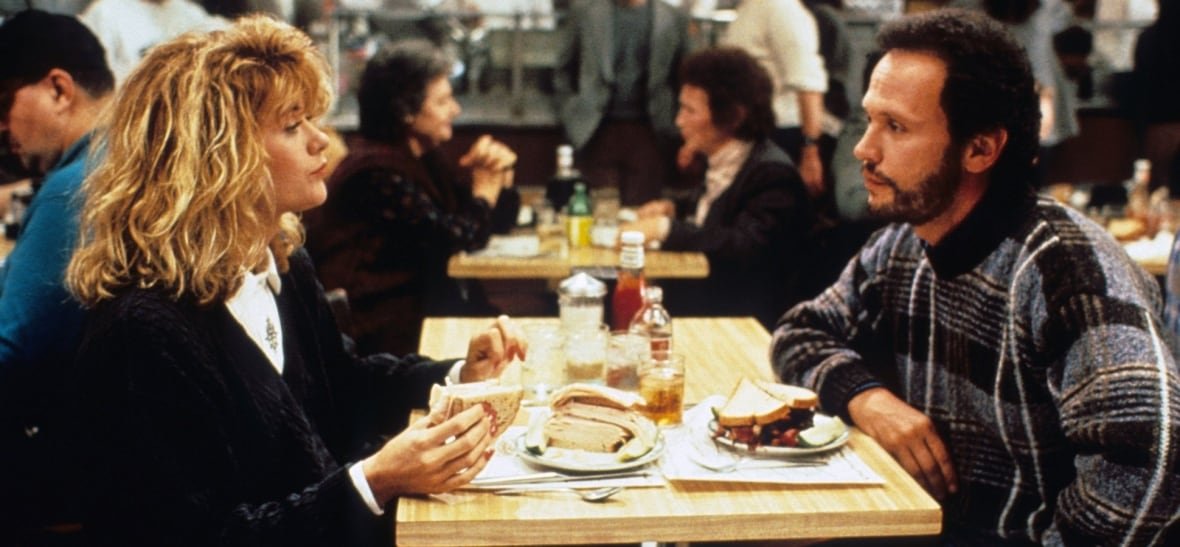 Two people sit at a diner table