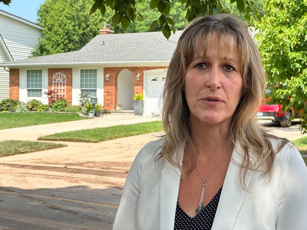 mayor-marianne-meed-ward A woman stands in front of a house.