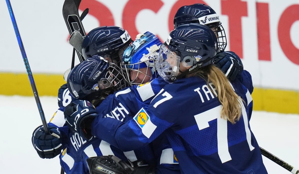 czech-republic-women-s-hockey-worlds-5 A group of five women's hockey players embrace on the ice.