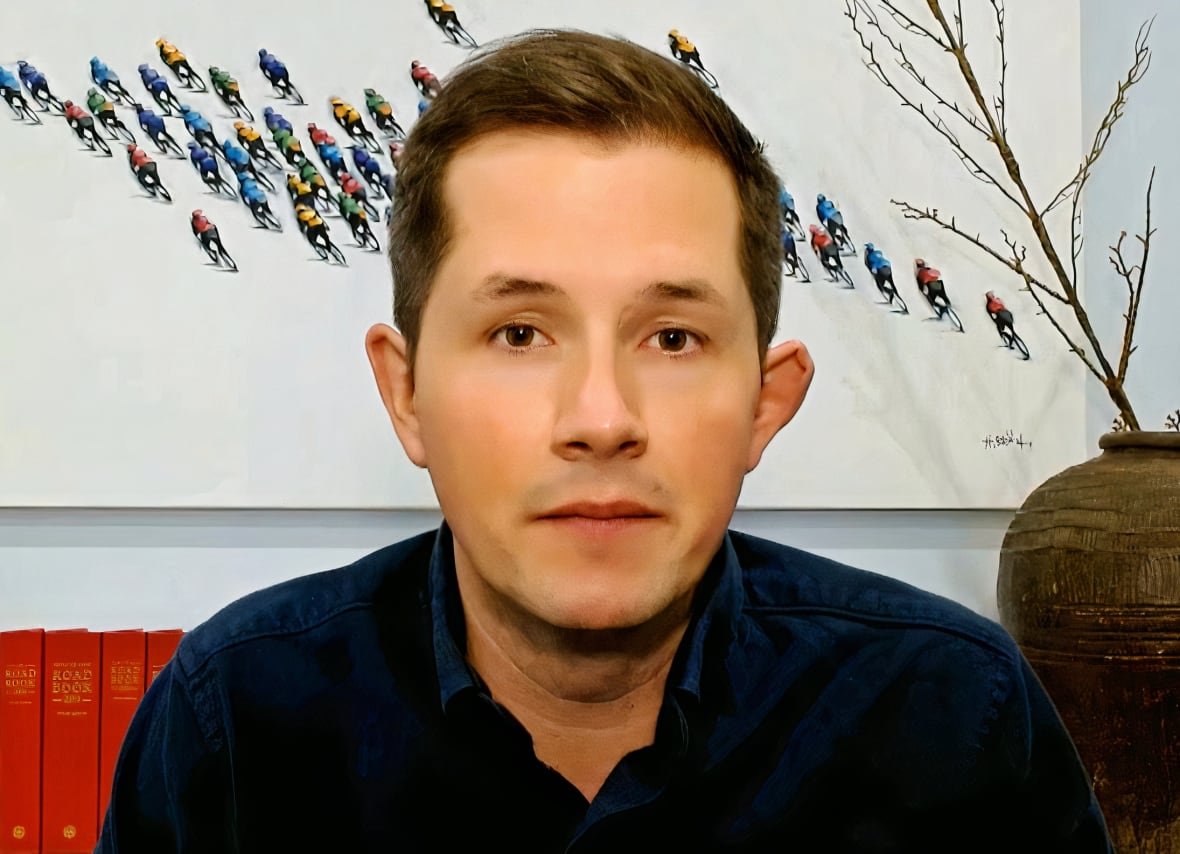 A close-up shot of a man with brown hair.
