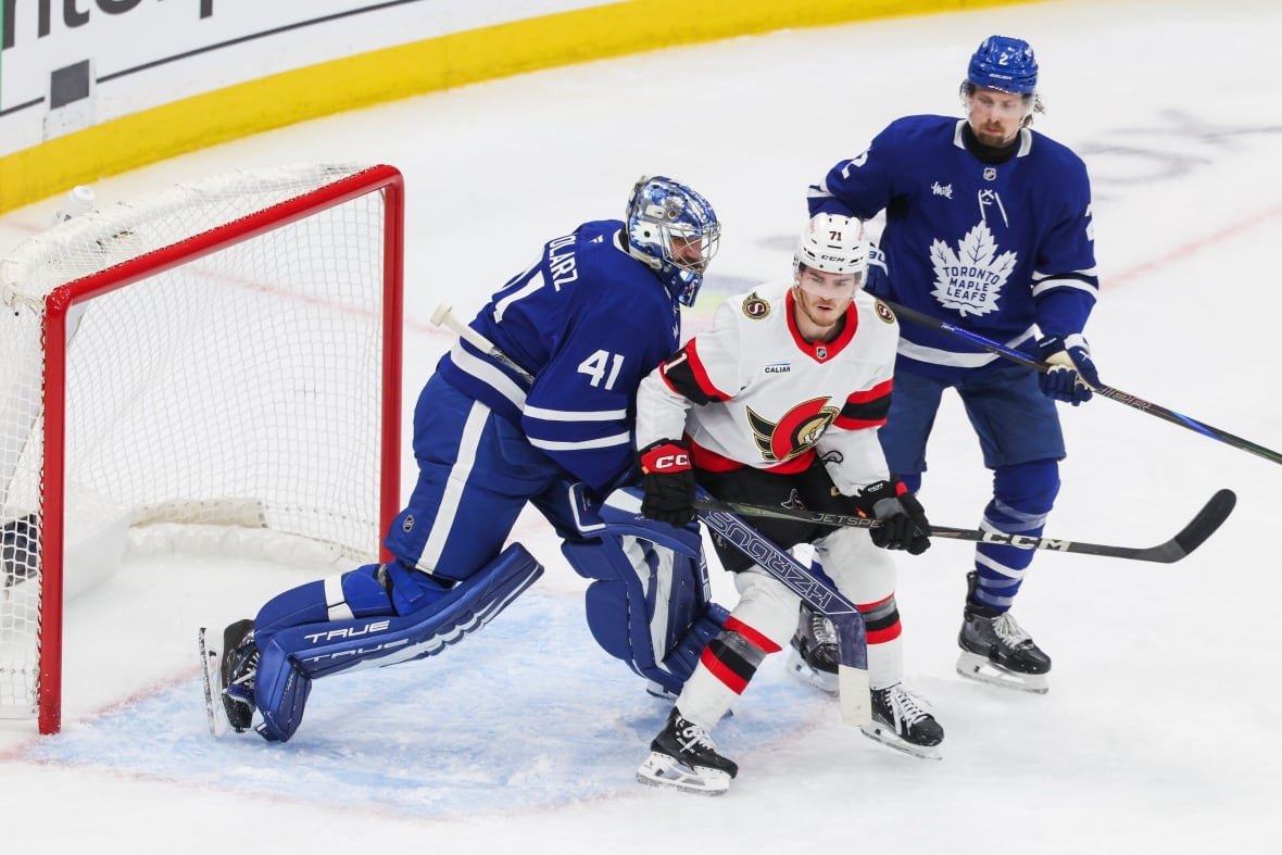 Toronto Maple Leafs goaltender Anthony Stolarz (41) ties up Ottawa Senators' Ridly Greig (71) while Toronto Maple Leafs' Simon Benoit (2) looks on during second period NHL playoff action in Toronto on Tuesday, April 22, 2025. THE CANADIAN PRESS/Nick Iwanyshyn