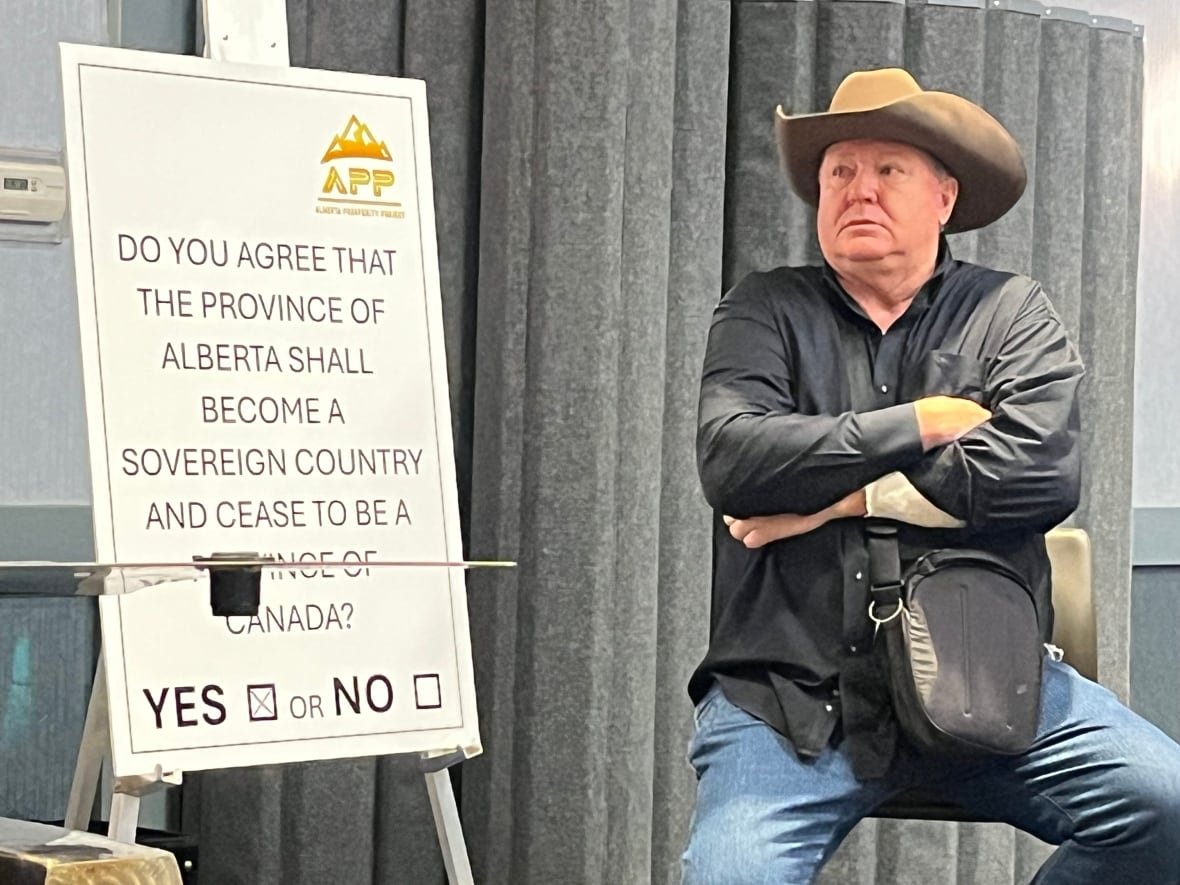 jeff-rath A man in a cowboy hat sits next to a referendum question.