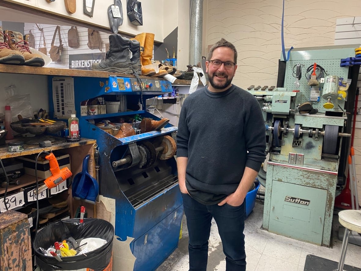 jeff-wickstrom A bearded man with glasses stands in the middle of a room with machines.