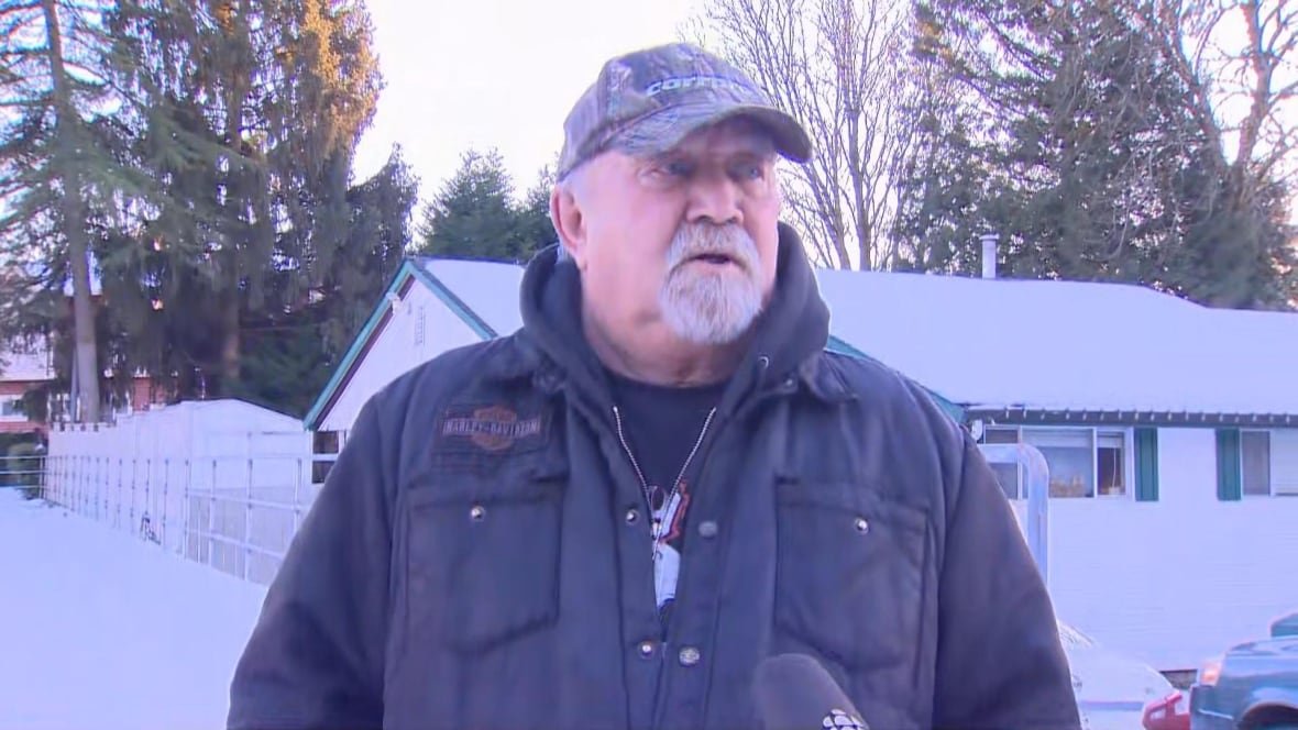 john-pedersen A white man with a white beard and baseball cap speaks on a snowy day.