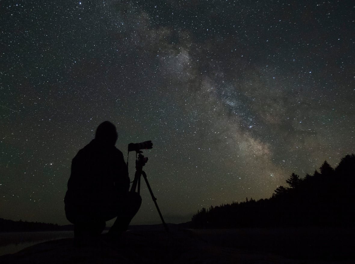 night-sky A man photographs the Milky Way over Algonquin Park in 2021.