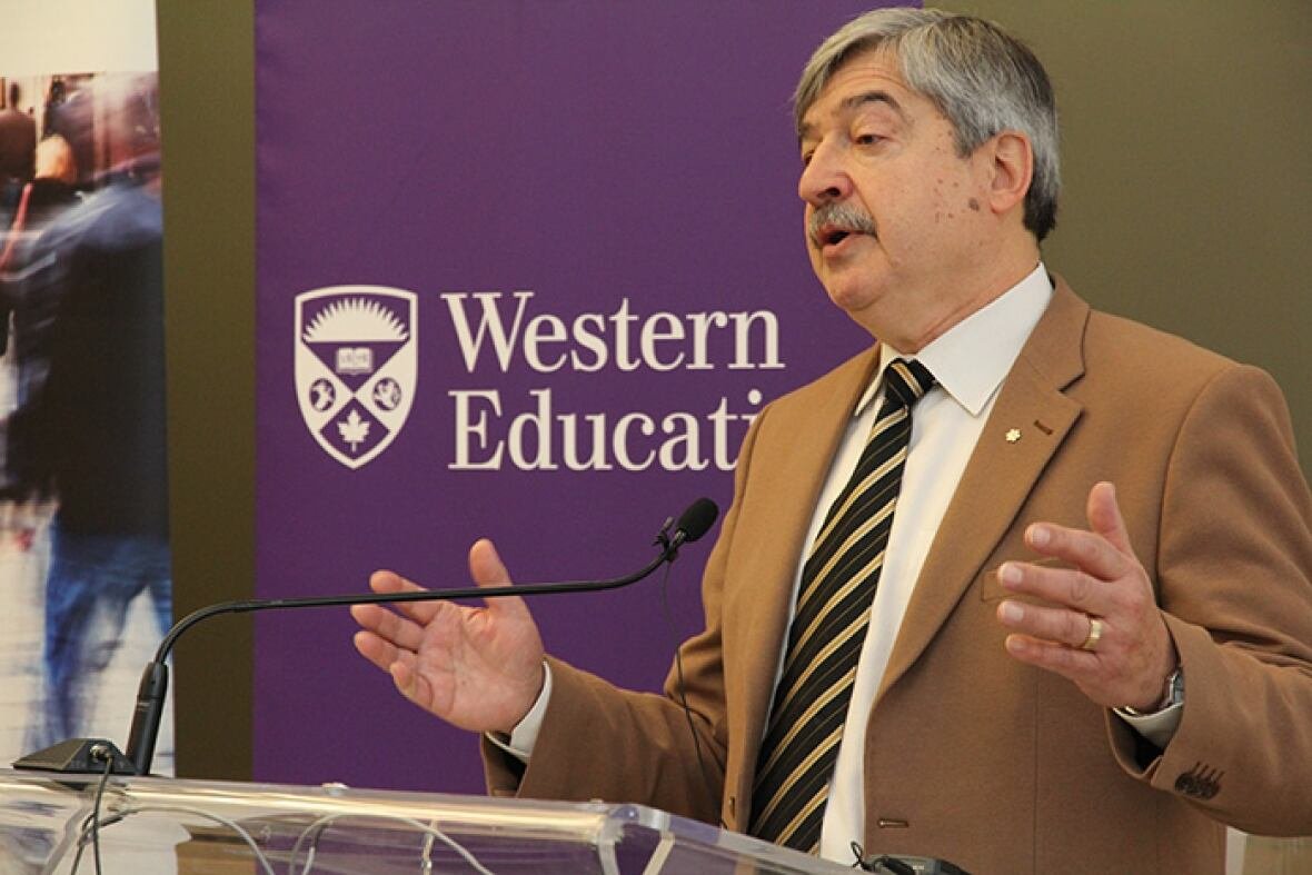 A man speaks at a microphone.