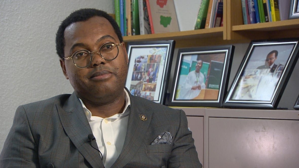 temitope-oriola A man in a suit sitting in an office