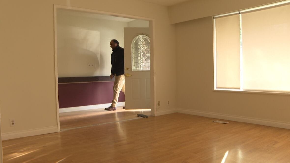 upkar-singh-tatlay-1 A man opens a door and steps inside a vacant room.