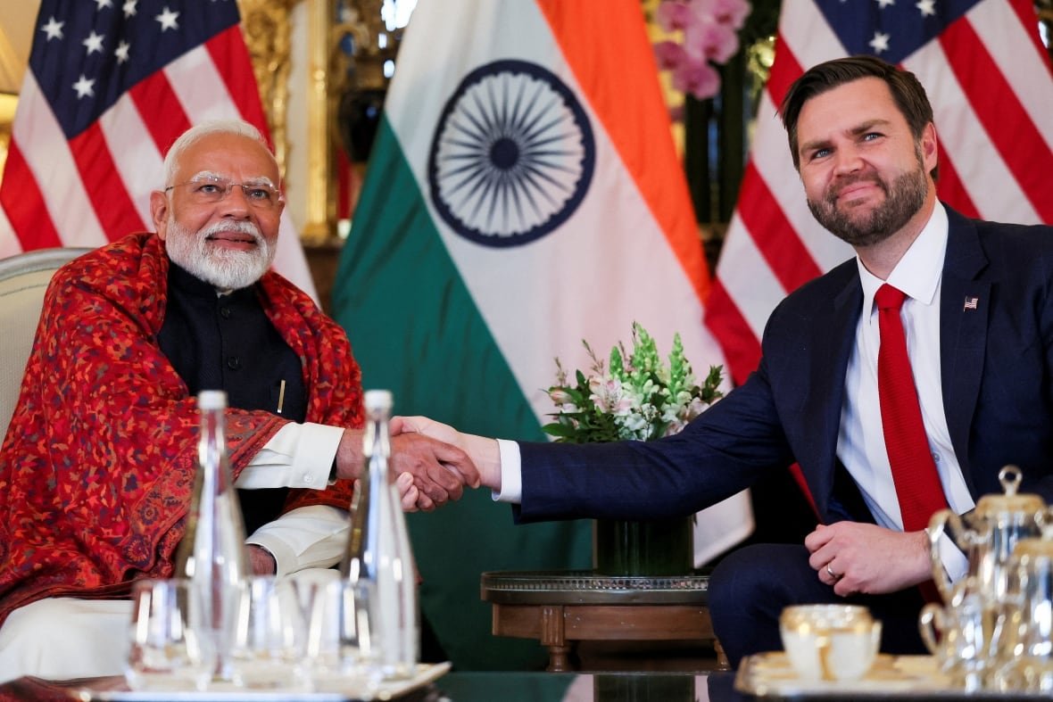 usa-india-energy Two men pose for a photo while shaking hands and seated.