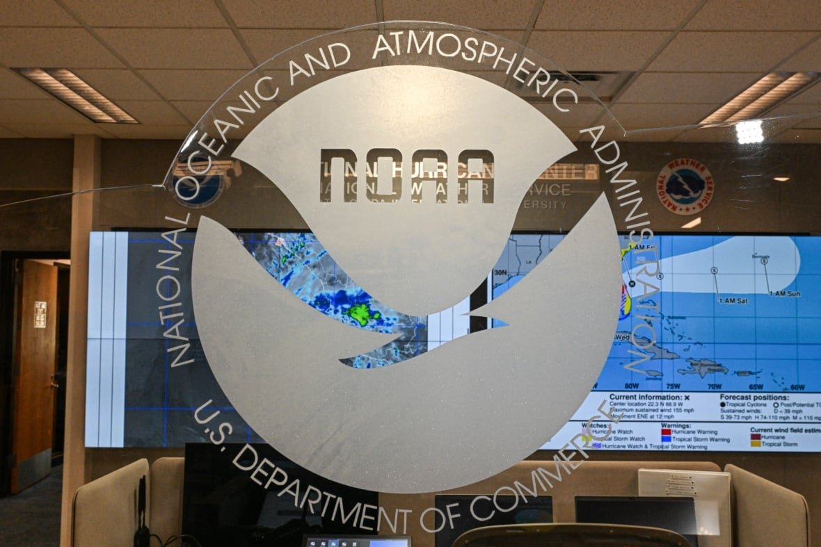 The NOAA logo on a glass wall.