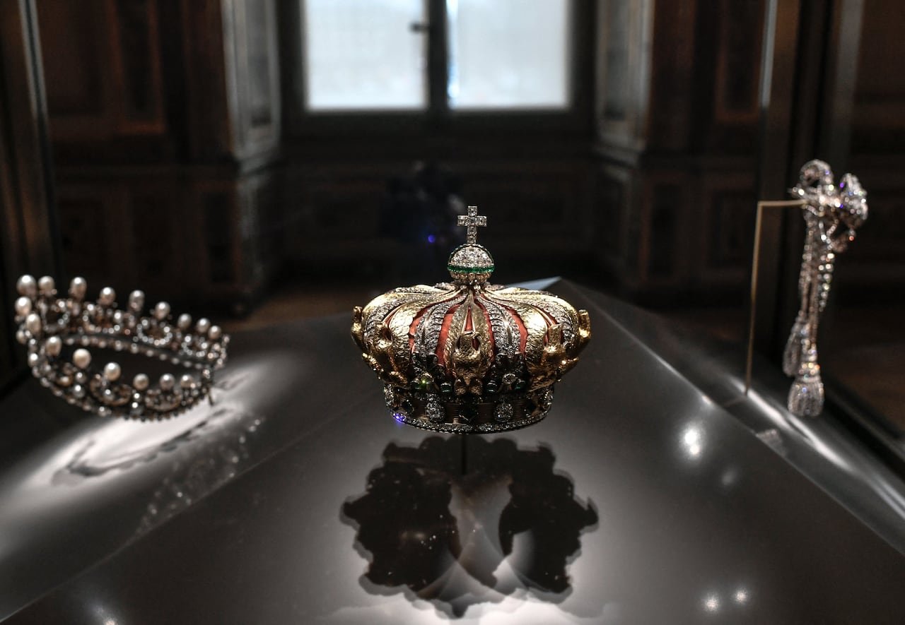 A jeweled crown in a display case