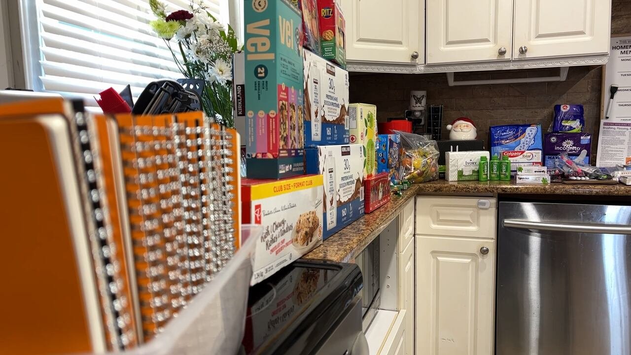 Notebooks, snacks, hygiene and menstrual products set up on a table