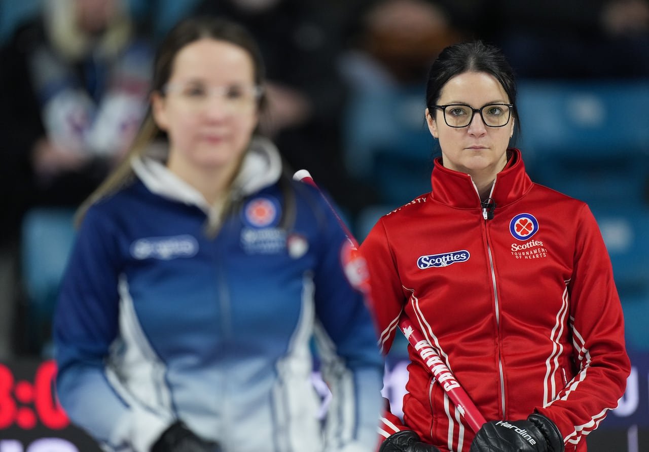 Team Canada skip Kerri Einarson supports Nova Scotia skip Christina Black during a playoff match.
