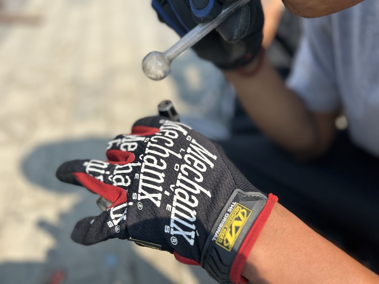 A hand holds a lighter to a drug pipe.