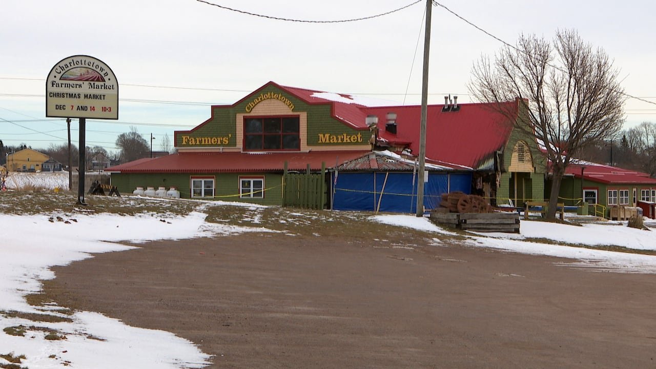 The Charlottetown Farmers’ Market building with fire damage and caution tape in the snow.
